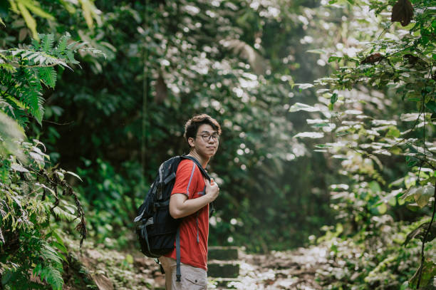 istock an asian chinese young man jungle trekking 1252396869