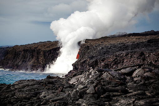 huge lava stream flowing at kalapana, kilauea volcano, big island, hawaii into the pacific ocean.