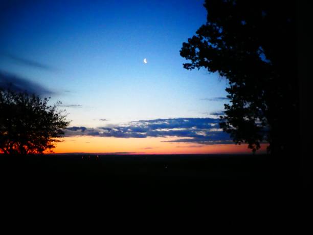 istock Early Morning Eastern Sky With a Crescent Moon Above the Horizon Before the Sun Rises 1252400139