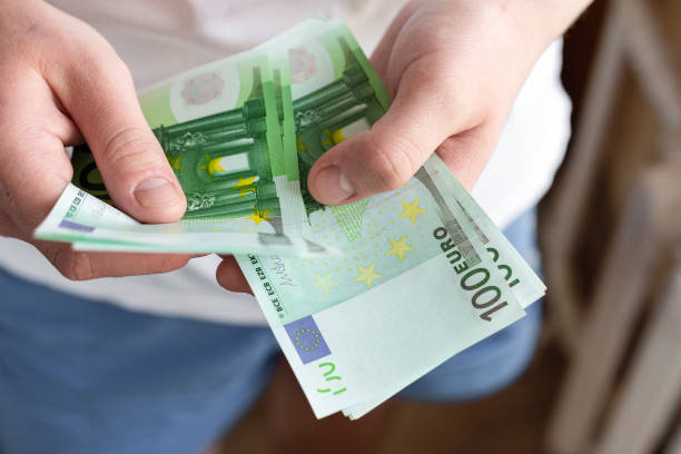istock Hands holding Euro banknotes currencies as financial activity 1252400208