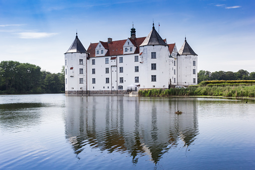Historic castle with reflection in the lake in Glucksburg, Germany