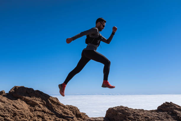 istock Man jump through the gap over the sky 1252400561