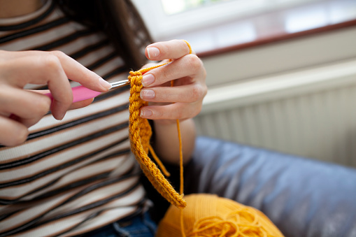 Blue Wool yarn and knitting needle on white background.