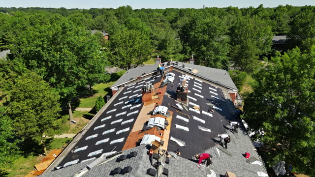 East Brunswick NJ US. 20 JUNE 2020: Roof repairs old roof replacement with new shingles of an apartment building