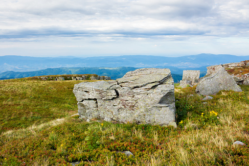 Stack of stones in front view, in backgrounds view from high mountains down to valley Trenta, Julian Alps, Slovenia