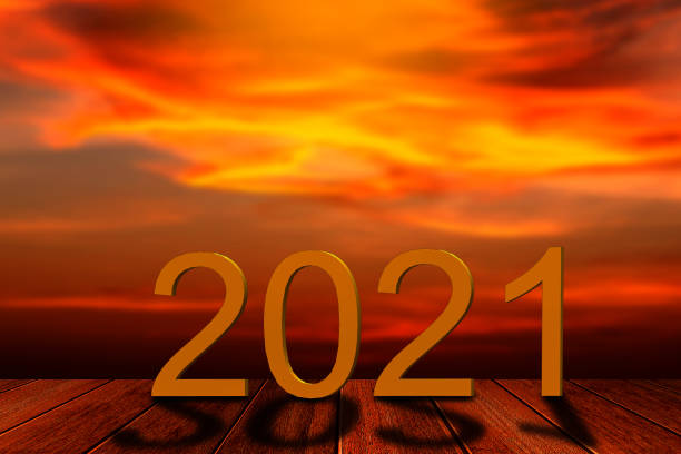 istock 2021 text on sand beach over blurred sunset sky background for new year concept. 1252404430