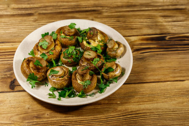 istock Baked mushrooms in plate on wooden table 1252404687
