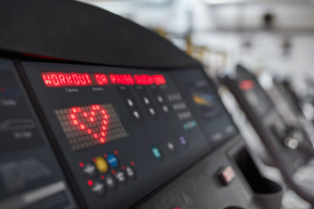 Close up on device screen with training parameters. Gym in background