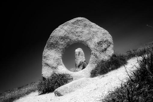 Black and white image of Men-An-Tol, a stone circle in Penwith, west Cornwall, UK