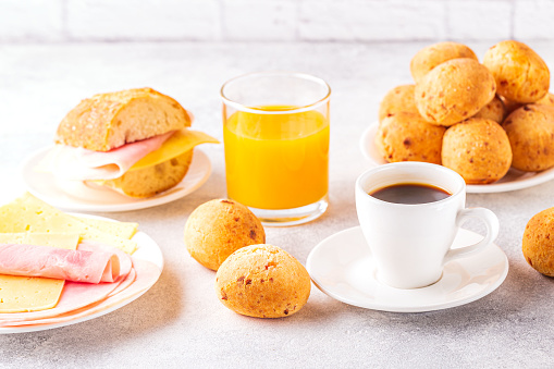 Traditional Brazilian breakfast - cheese bread, coffee, ripe fruit, selective focus.