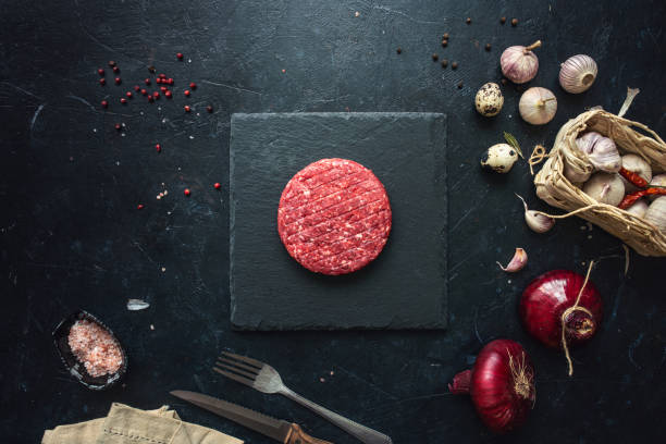 istock Raw minced beef burgers with spices layout 1252407106