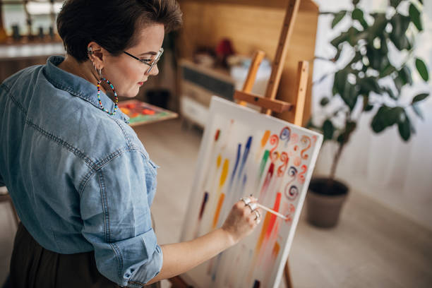 istock Young artist painting on canvas 1252407327