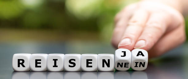 istock Travelling despite the Corona virus? Hand turns dice and changes the German expression 
