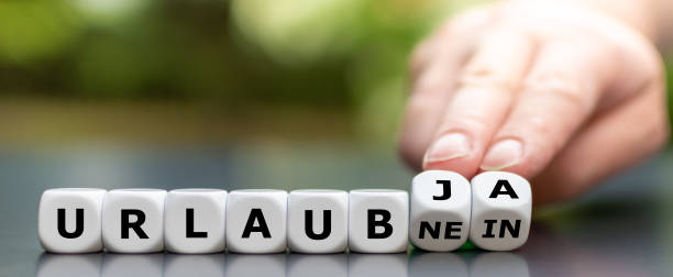 istock Vacation despite the Corona virus? Hand turns dice and changes the German expression 