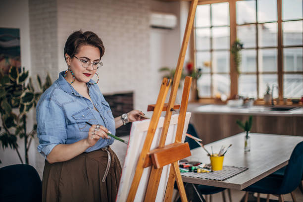 istock One female artist with eyeglasses painting in her studio 1252408607