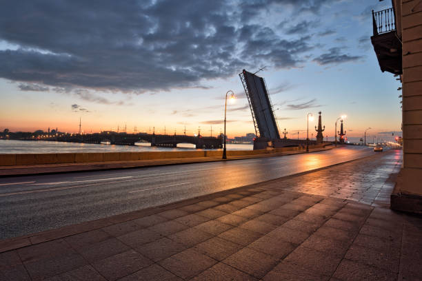 City landscape at night.The streets are lit by electric light.The bridge is raised for the passage of ships.