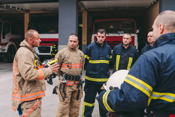 Firefighters at work Fire chief talking to his team chief of staff stock pictures, royalty-free photos & images