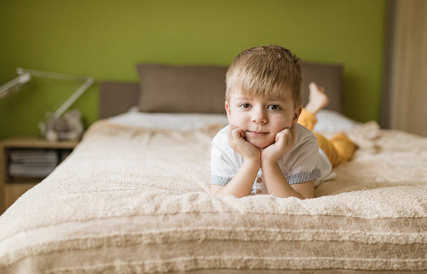 istock Little boy lying on front in bedroom 1252410317