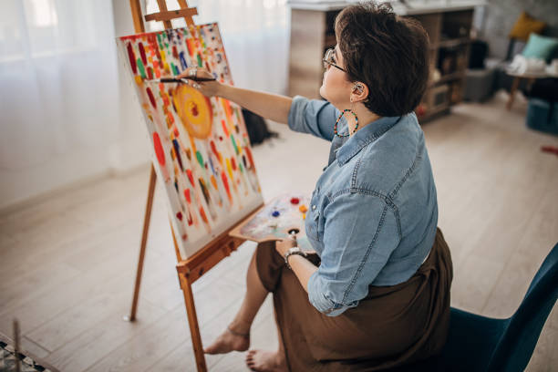 istock Artist with eyeglasses working in her studio 1252411145