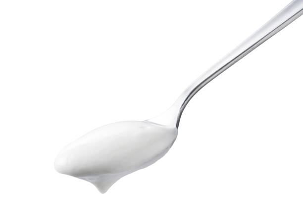 istock Spoon and yogurt on a white background 1252414275