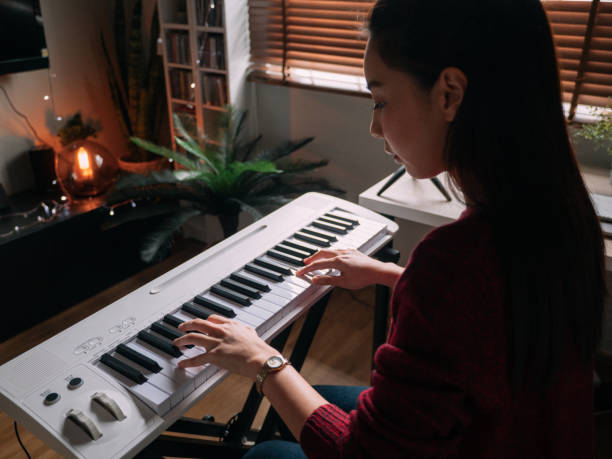 istock Young Woman Giving Piano lesson On Internet With Video Tutorial At Home. 1252414410