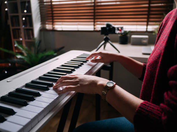 istock Millennial woman learning to playing keyboard piano at home 1252414943