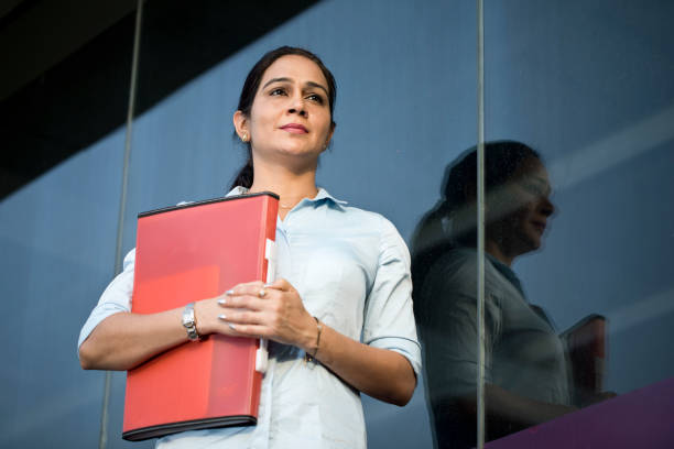 istock Businesswoman with file outside office 1252416686