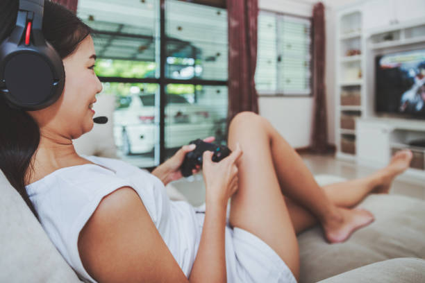 istock Woman play game at home 1252416803