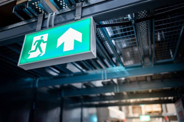 Emergency exit sign or fire exit sign Green emergency exit sign or fire exit sign showing the way to escape with arrow symbol. exit sign photos stock pictures, royalty-free photos & images