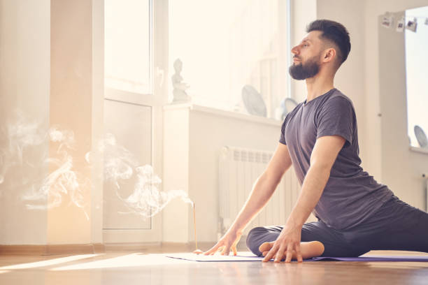 istock Serene young man doing pigeon pose in yoga studio 1252417201