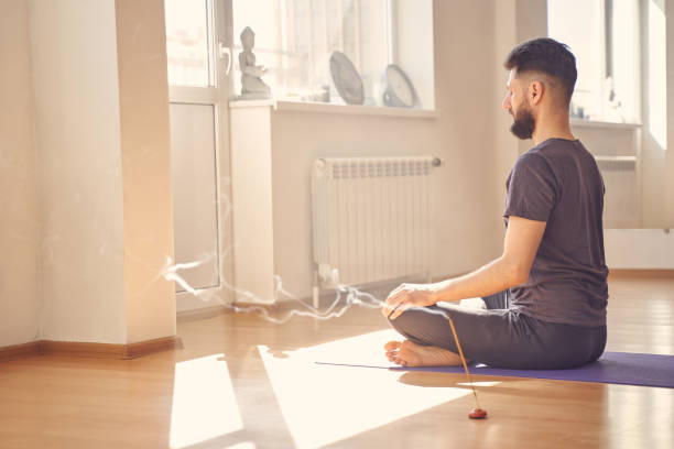 istock Bearded young man meditating in yoga position 1252417226
