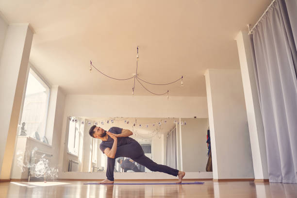 istock Male yoga practitioner doing prayer twist pose 1252417247