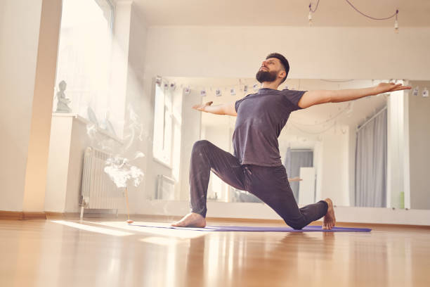 istock Handsome bearded man in shirt doing yoga exercise 1252417259