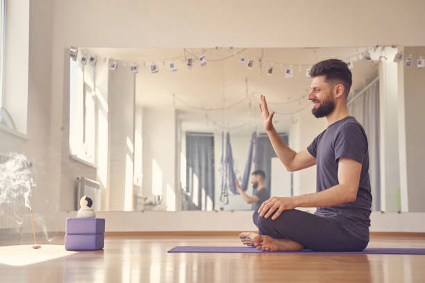 istock Male yoga instructor using wireless robot camera during yoga session 1252417283