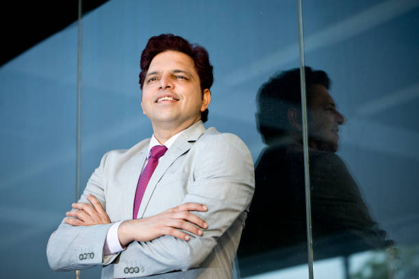 istock Businessman daydreaming while looking away outside office building 1252417931