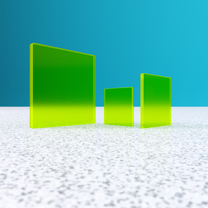Three green glass tiles against a blue background