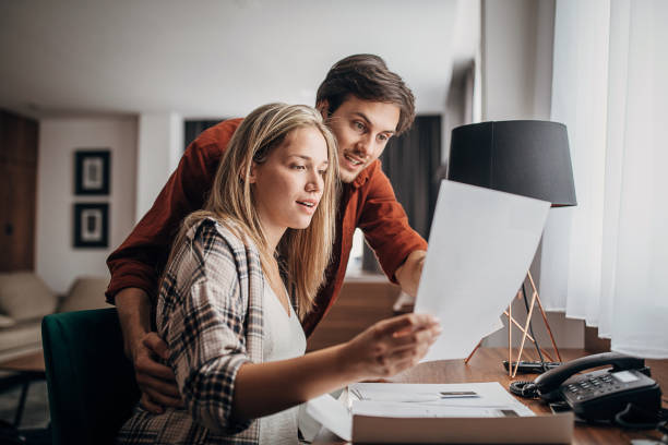 istock One beautiful young couple reading a guide in a hotel room 1252419022