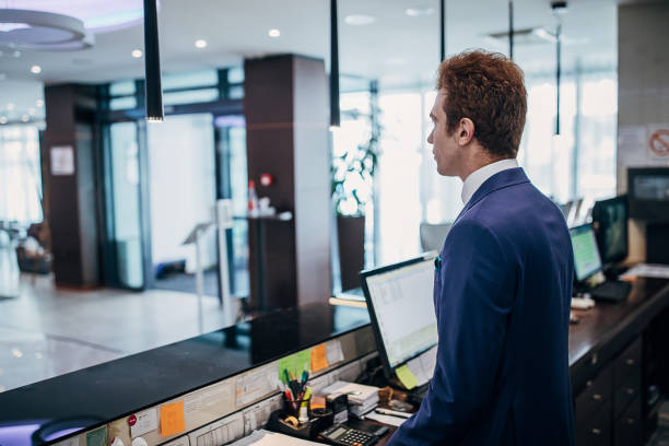 istock Male receptionist working in hotel lobby 1252419743