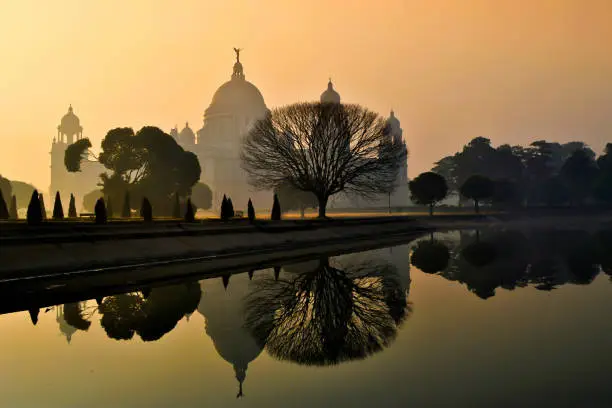 Victoria memorial Kolkata the landmark monument of the city of joy is a popular tourist destination. A foggy winter morning sunrise.