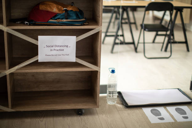 istock Shelf with backpacks and information about social distancing 1252420173