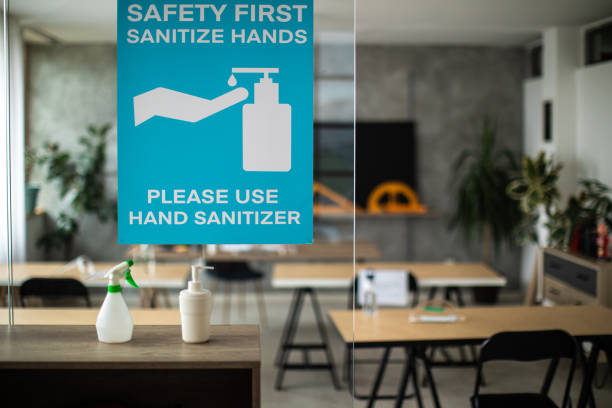 istock Empty classroom with information about covid-19 illness prevention and safety on sliding doors at classroom entrance 1252420324