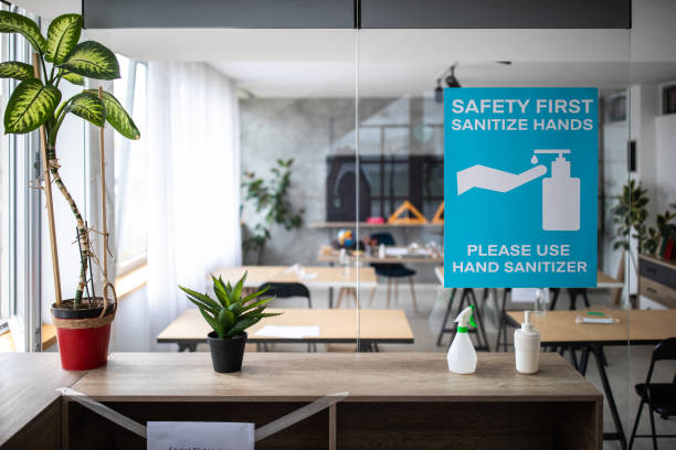 istock Empty classroom with information about covid-19 illness prevention and safety on sliding doors at classroom entrance 1252420670
