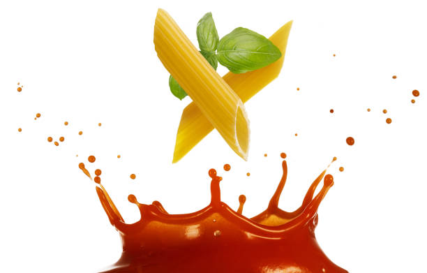 istock italian penne and basil in splashing tomato sauce 1252421523