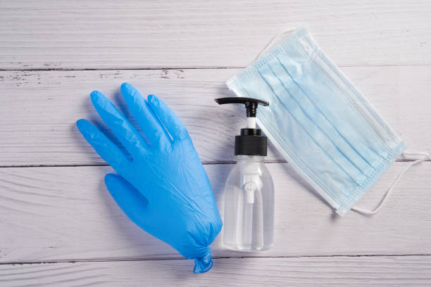 istock hand glove and sanitizer 1252421667