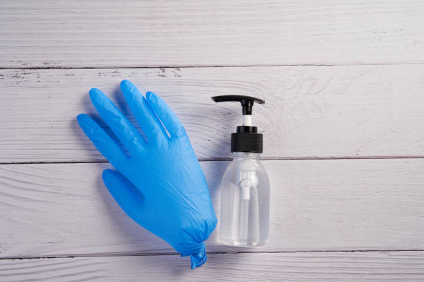 istock hand glove and sanitizer 1252421739