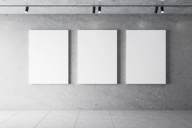 istock Modern concrete interior with lamps on ceiling and three billboards 1252422053