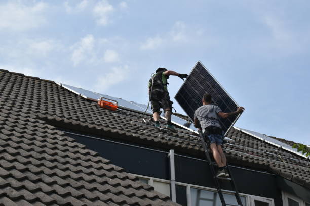 Solar panel mounting on sloping roof with roof tiles by professional  installers Warmond, the Netherlands - June 02 2020: Professional placemat of compete solar installation, which delvers power back to the grid via a convertor. The installation is mounted on on an existing sloping roof with roof tiles, using special mounting equipment. solar power station solar panel house solar energy stock pictures, royalty-free photos & images