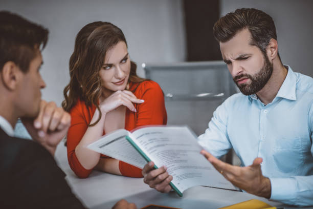 istock Disappointed and annoyed man reading a legal document 1252436814