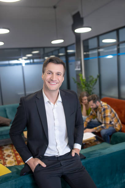 istock Handsome young professional standing in his office 1252438632
