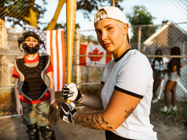 istock Young woman playing softball 1252442874